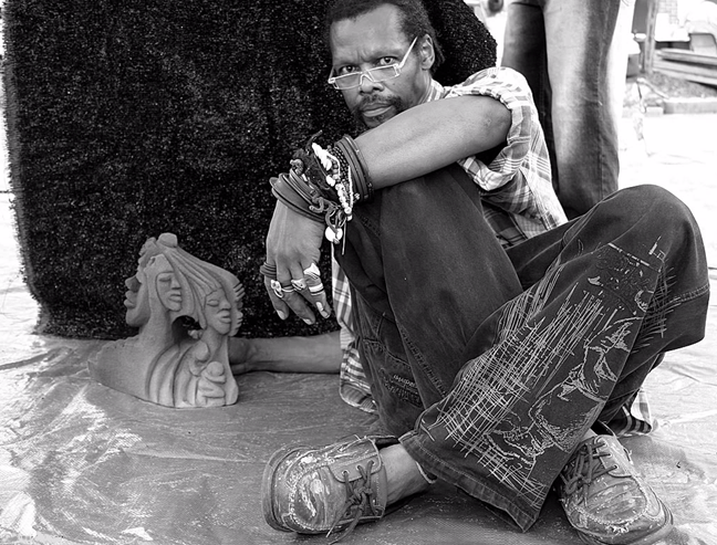 Lonnie Holley with one of his sandstone sculptures.